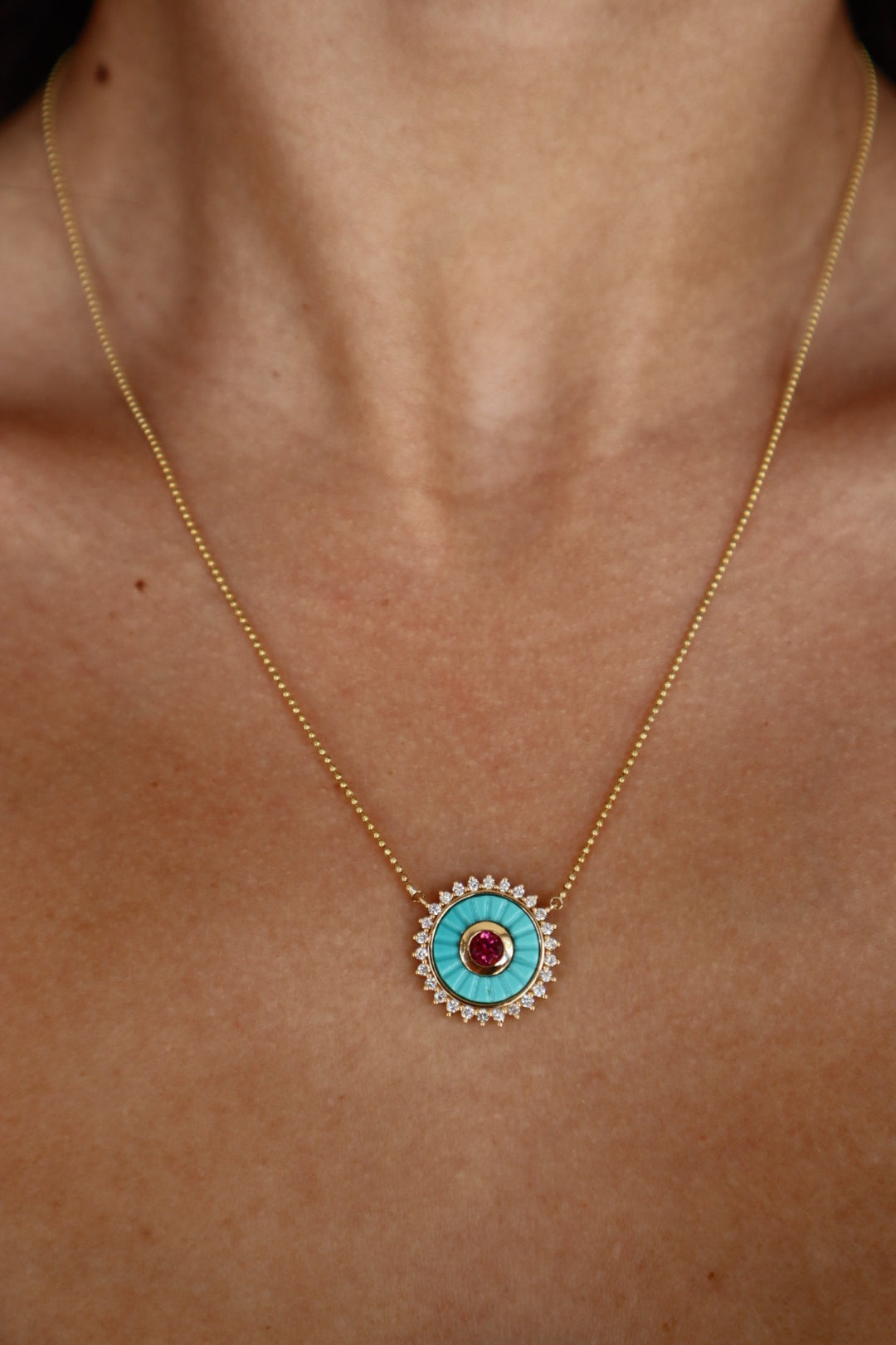 Mandala Medallion Necklace extreme close up showing turquoise side on model's neck