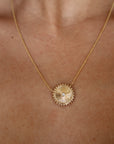 Mandala Medallion Necklace extreme close up showing gold side on model's neck