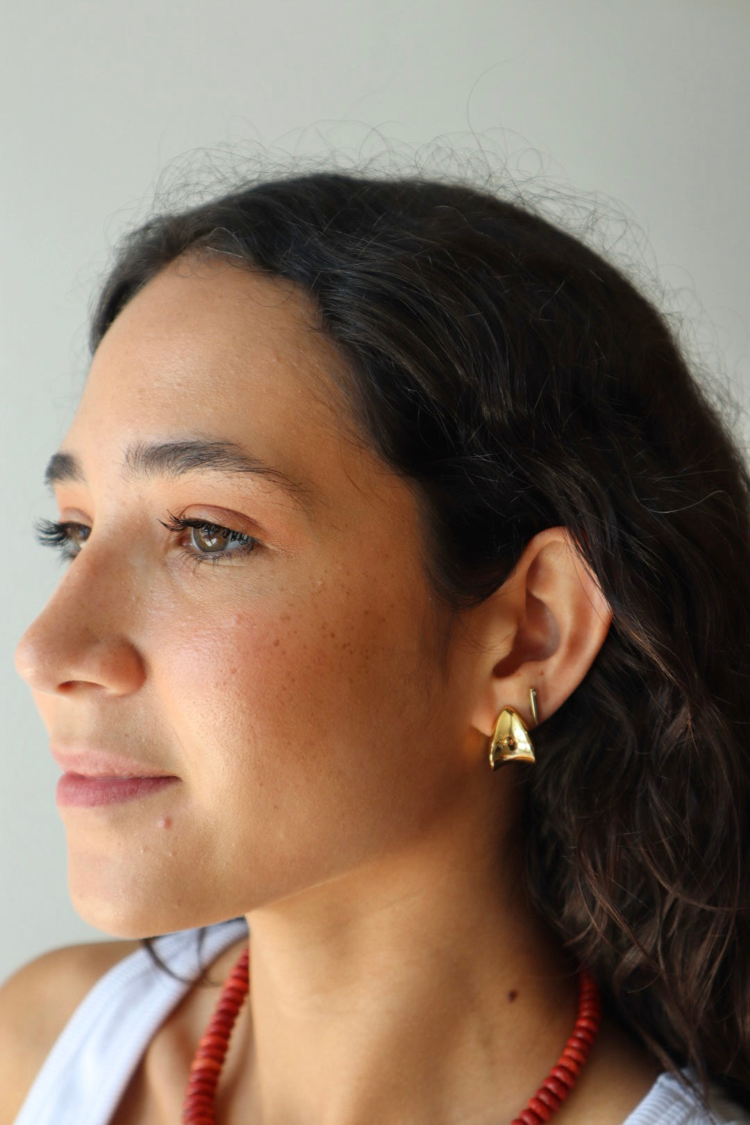 Small Margaux Puff Earrings farther back front and partial side view on model