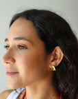 Small Margaux Puff Earrings farther back front and partial side view on model