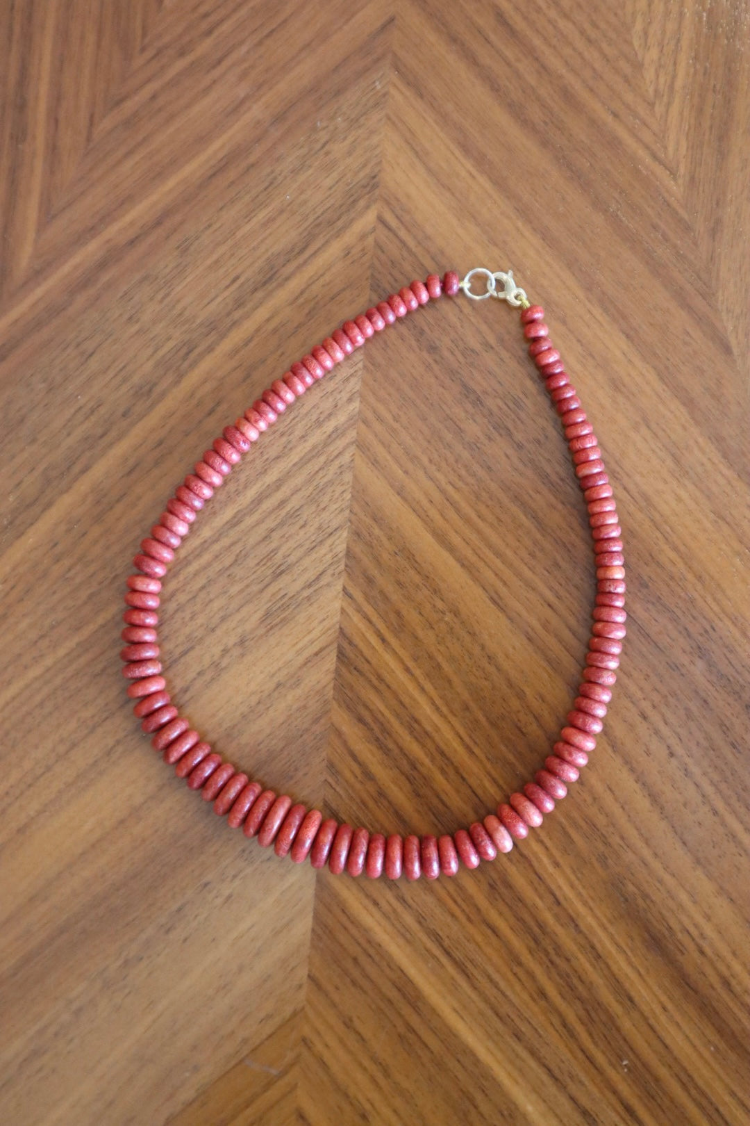 Graduated Coral Gemstone Necklace flay lay on wooden table