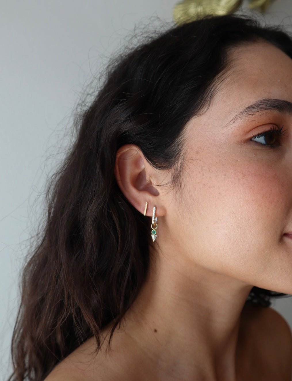 Single Tiny Emerald Pyramid Charm side view on model