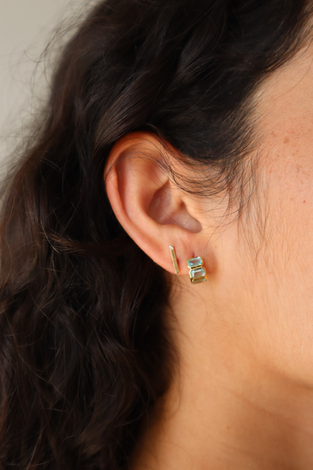 Sunset Huggie Hoops in Aqua close up side view