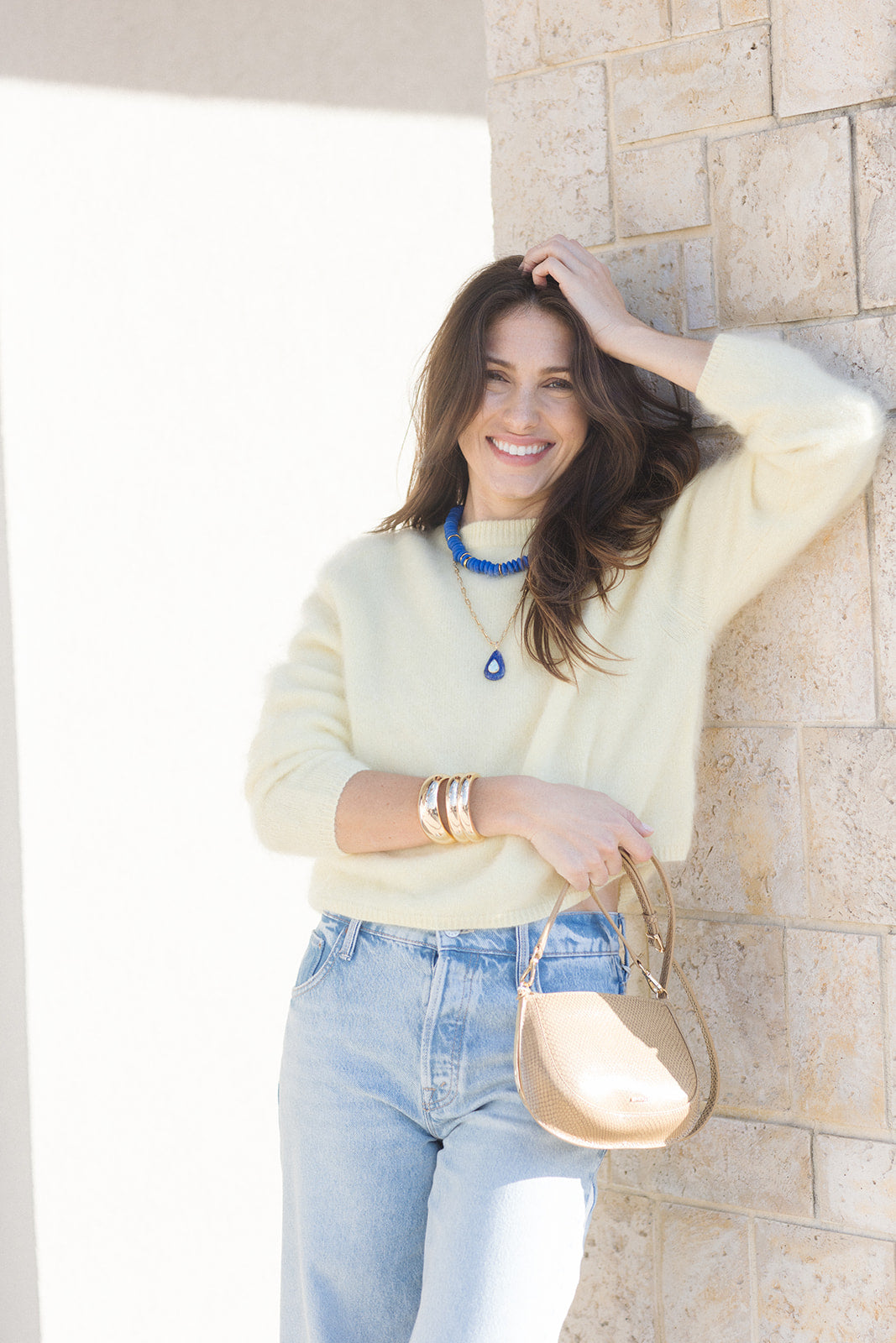 Logan Debossed Leather Crossbody held by model