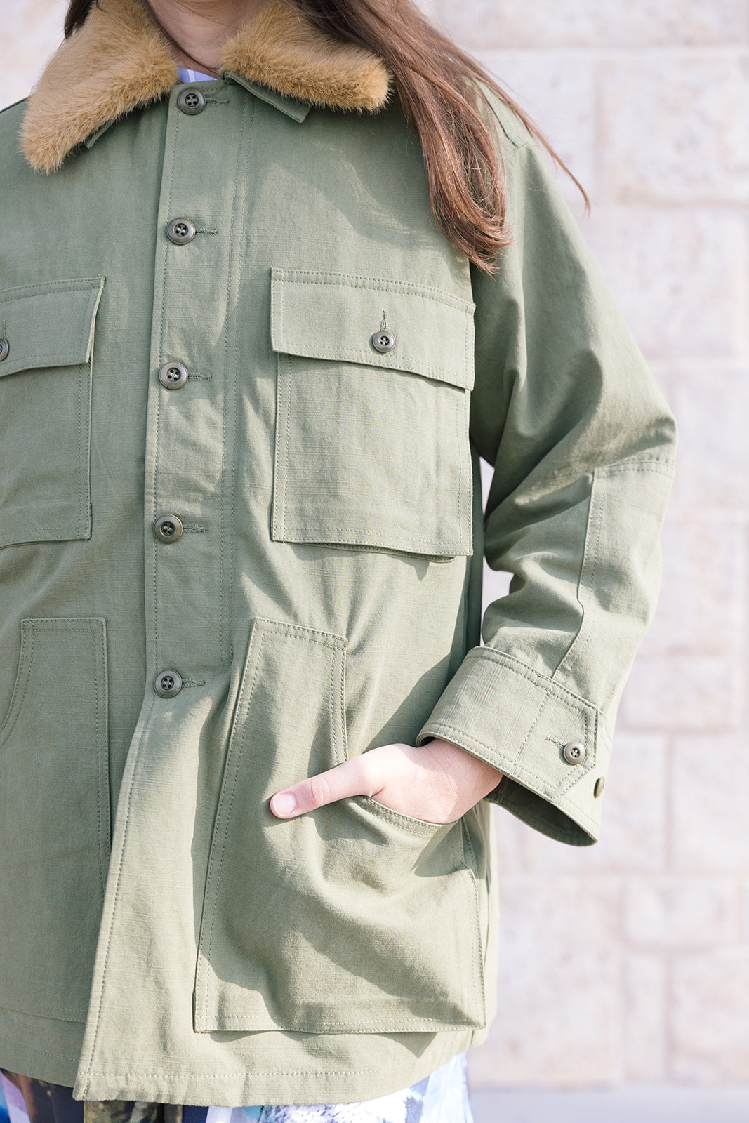 The Quilted Liner Parka close up with model's hand in pocket