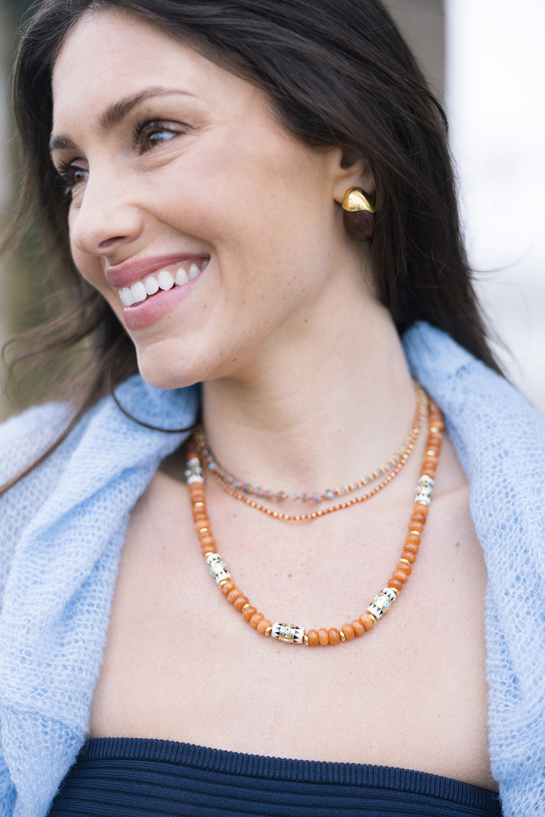 By the Sea Necklace in Terracotta close up view with other necklaces