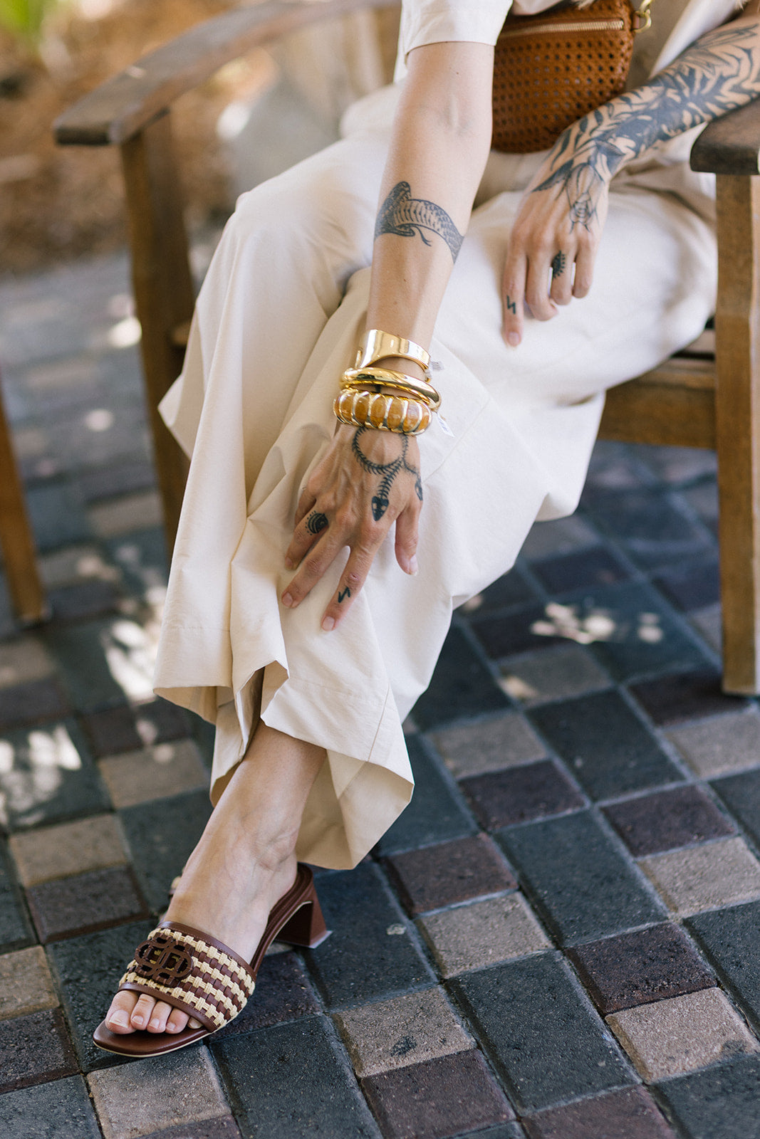 Person wearing Sydney Rope Woven Block Heel and bracelets on a tiled floor