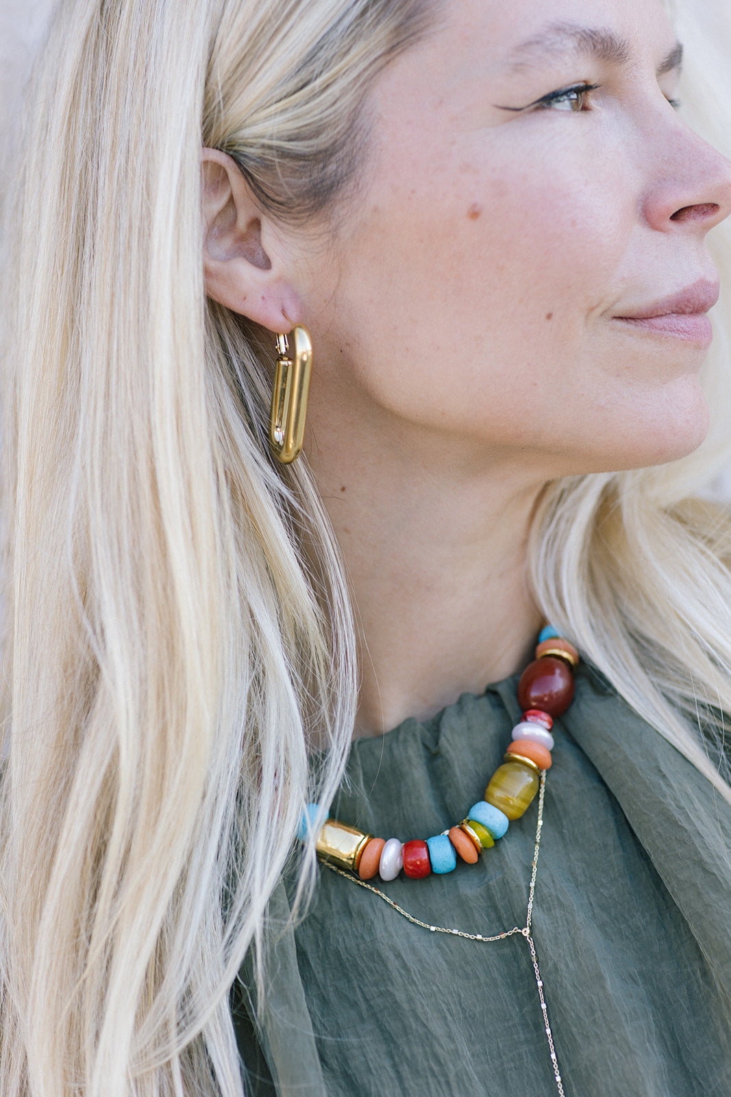 Close-up of a woman wearing colorful beaded necklace and Earrings Iona