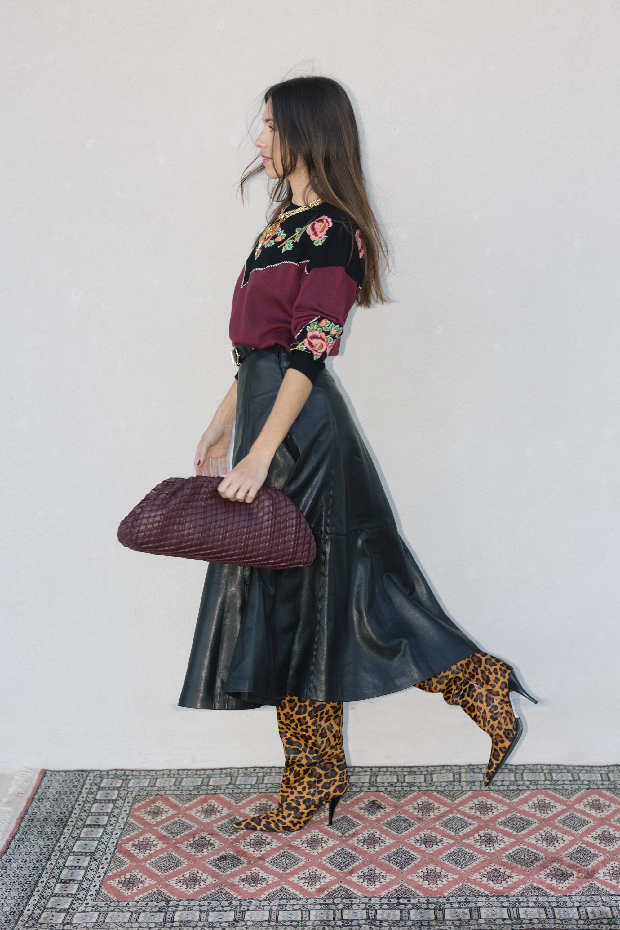 model wearing burgundy clutch
