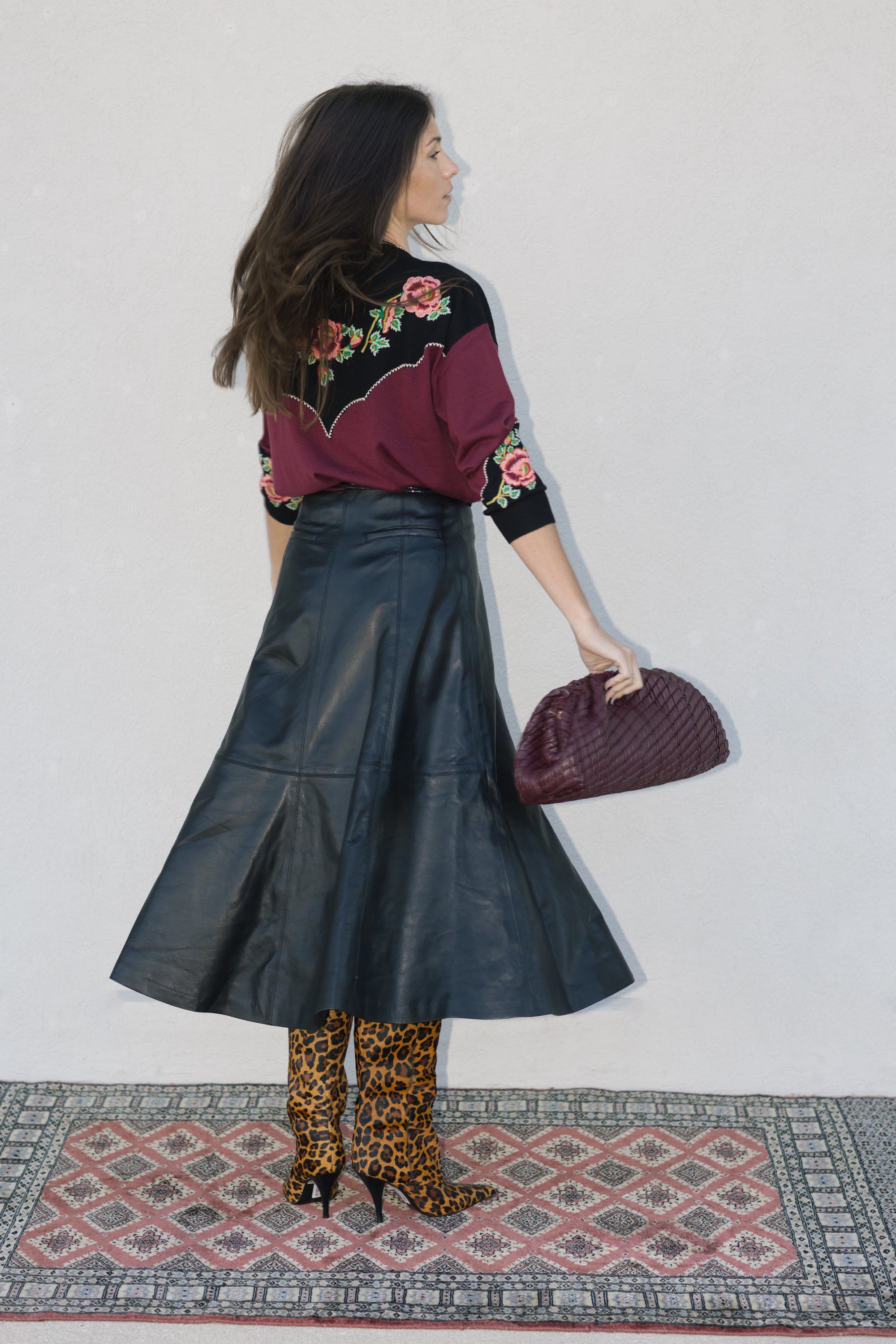 model wearing burgundy clutch