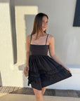 Mini Strap Dress with Frills front view, model holding out skirt