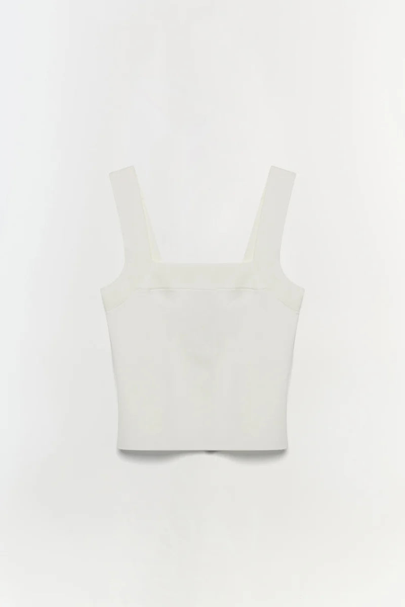 White crop top on a light gray background