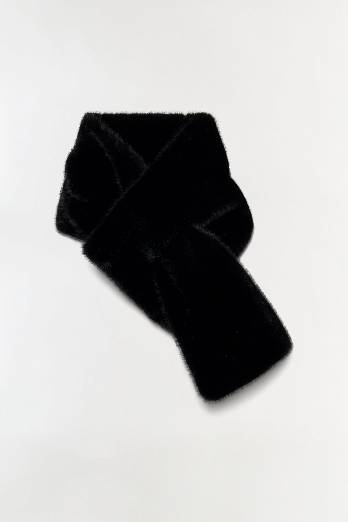 A black fuzzy knit scarf, possibly faux fur or velour, styled in a loose knot on a plain white background.