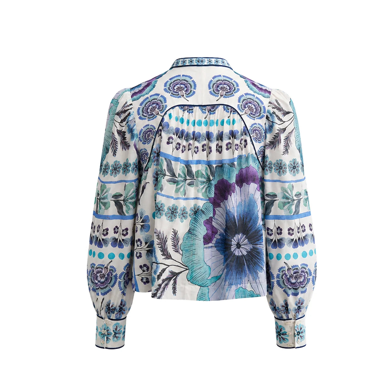 A long-sleeve blouse shown from the back, featuring a cream base with a vibrant blue, purple, and green floral and geometric pattern, back