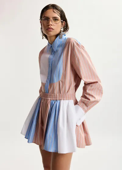 Woman wearing a colorful outfit with a white background