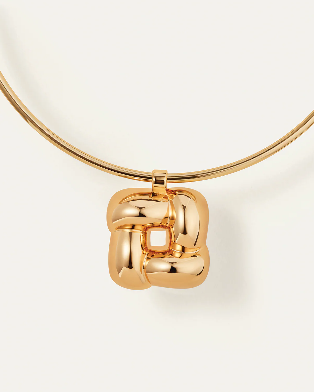 Gold necklace with a pendant on a white background