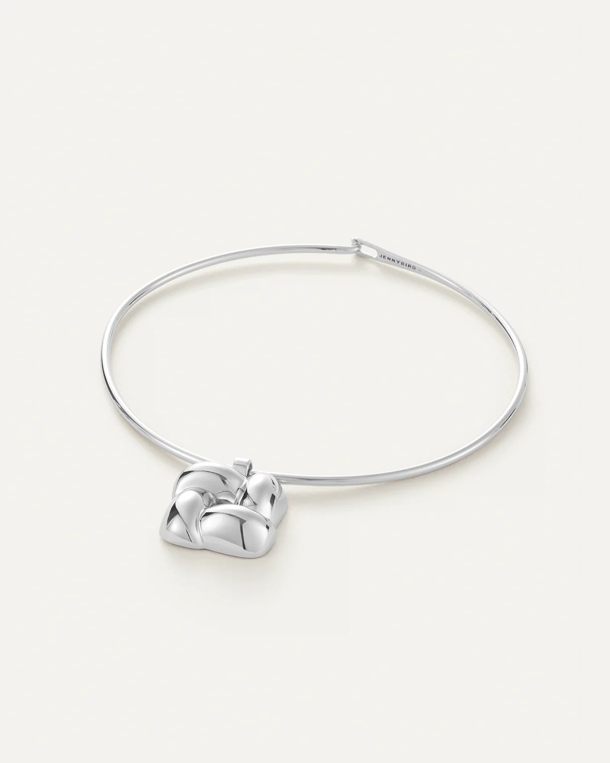 Silver heart-shaped pendant on a white background