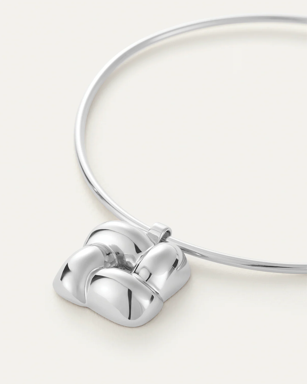 Silver necklace with a heart-shaped clasp on a white background