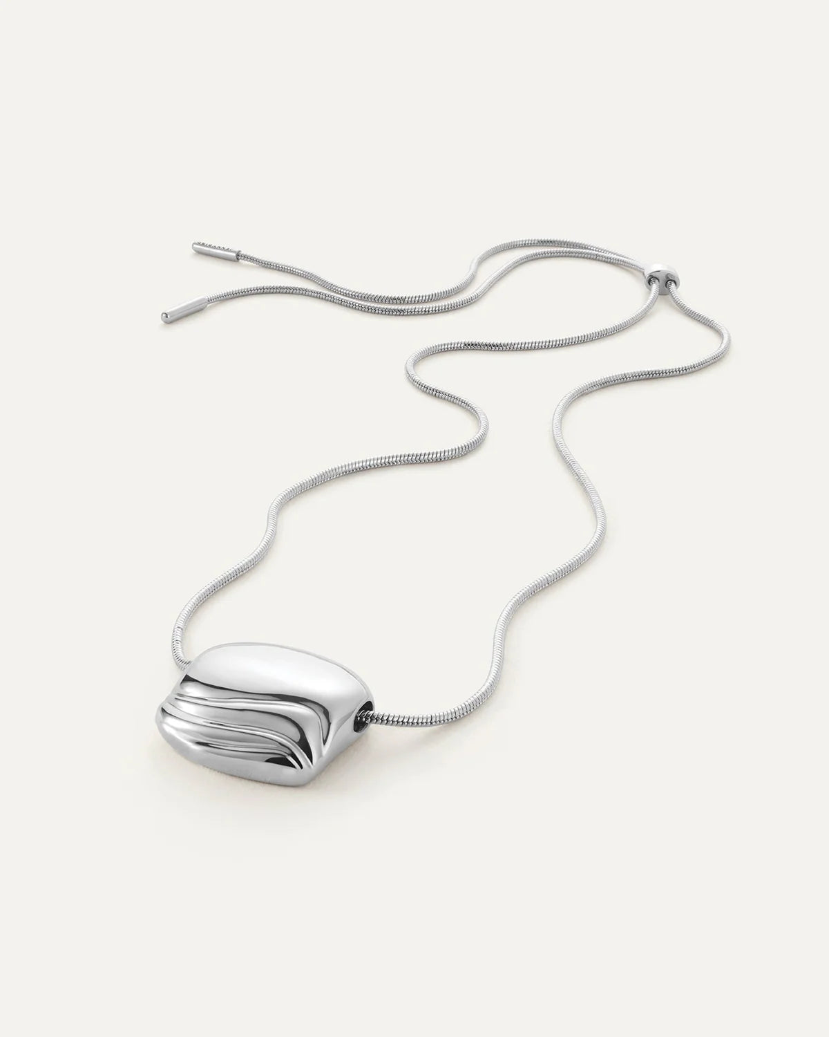 Rue Pendant Necklace Silver laid on white surface