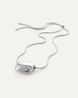 Rue Pendant Necklace Silver laid on white surface