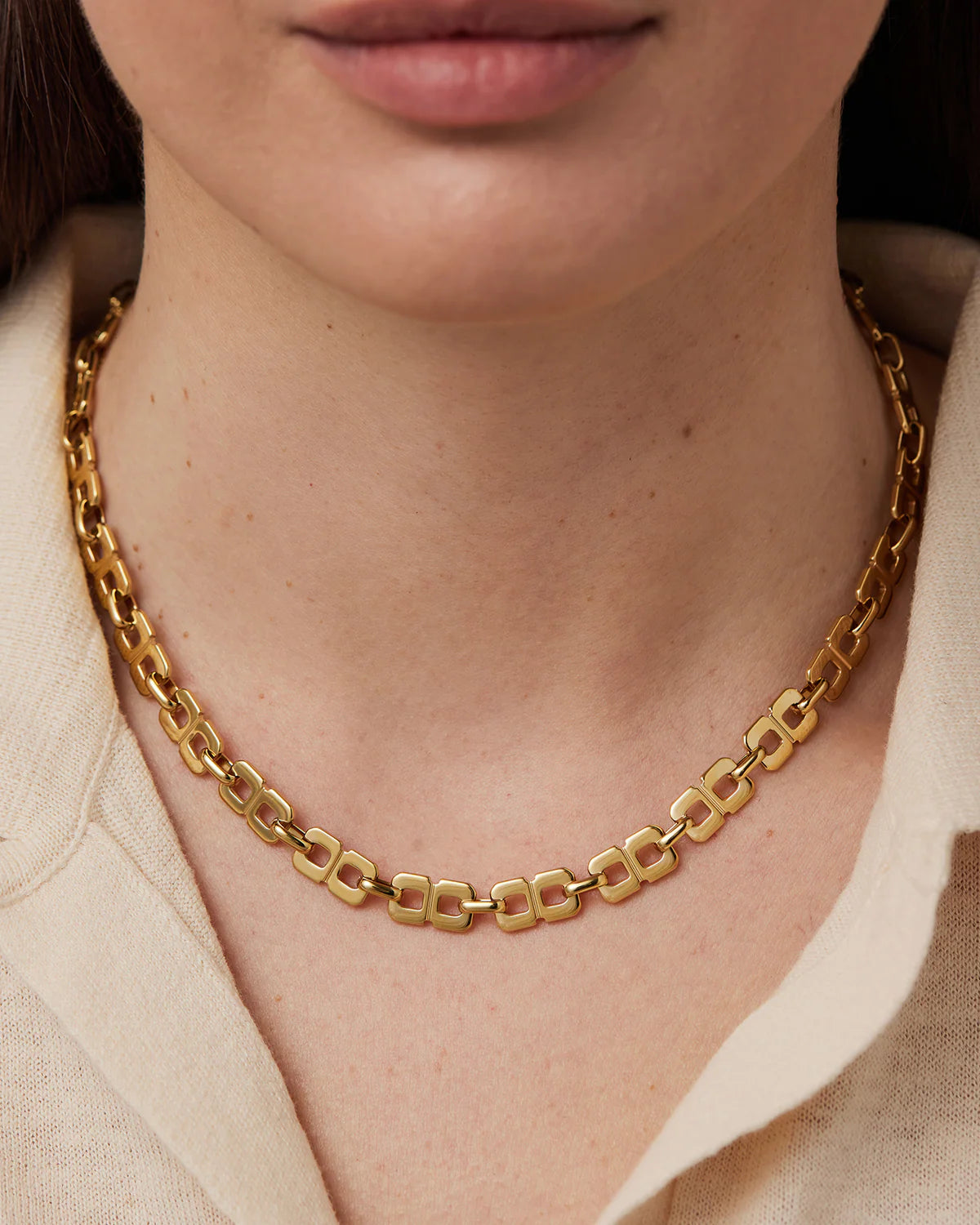 Gold chain necklace worn by model