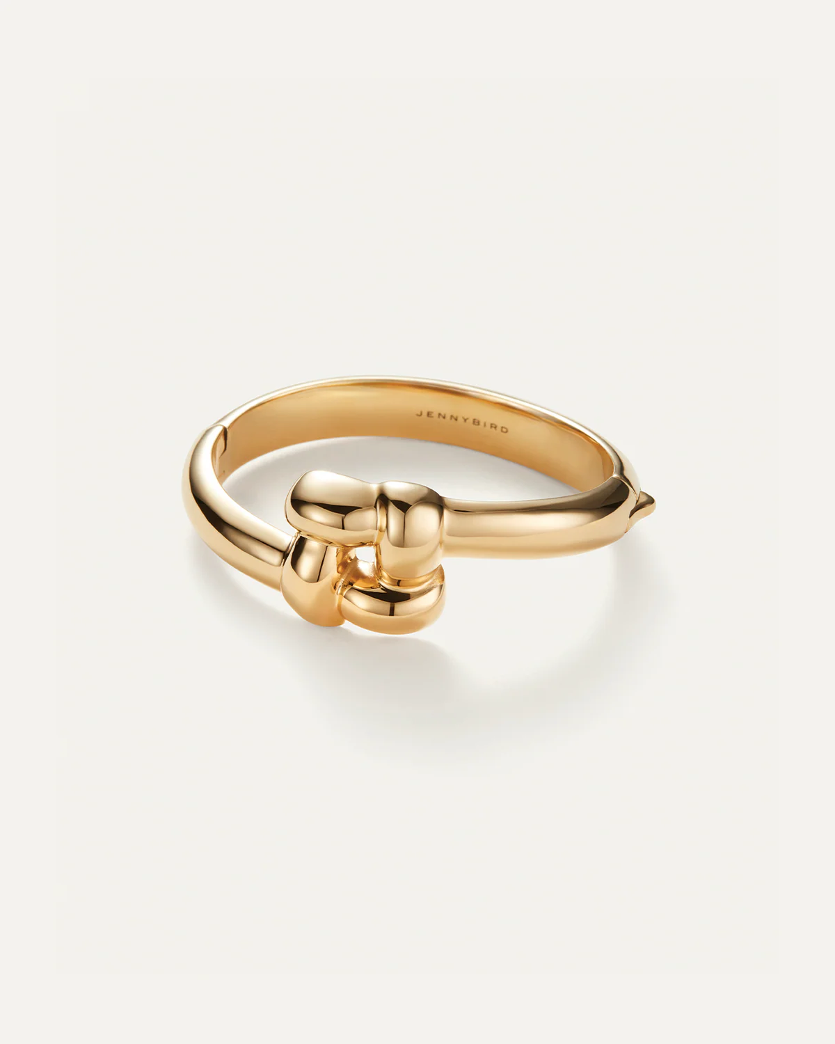 Gold ring with a unique design on a white background