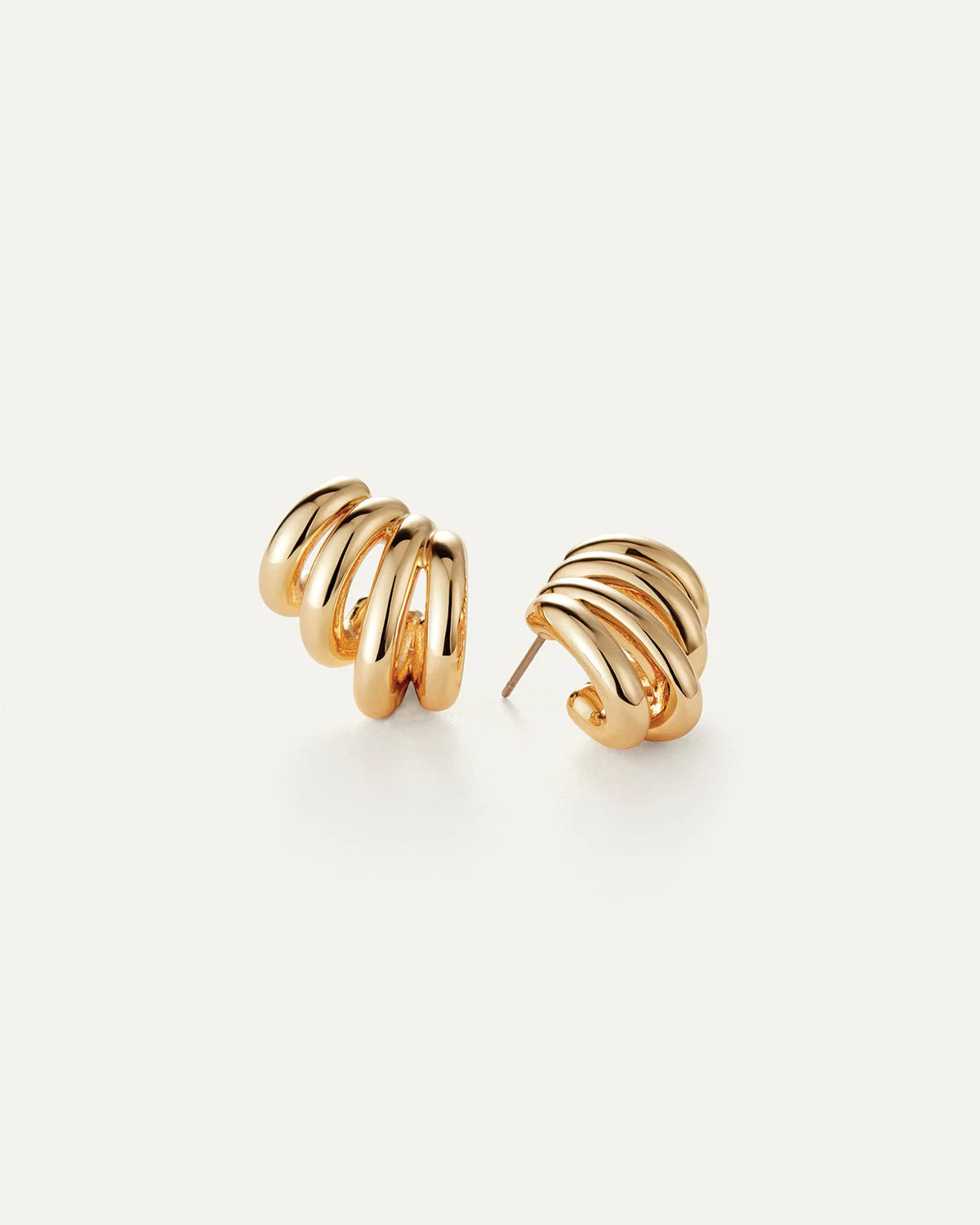 Gold spiral earrings on a white background