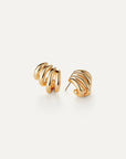 Gold spiral earrings on a white background