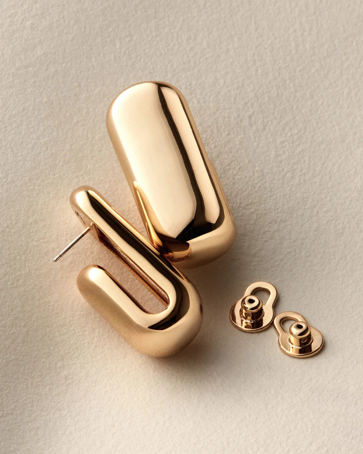 gold plated hoops on a white background