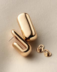 gold plated hoops on a white background