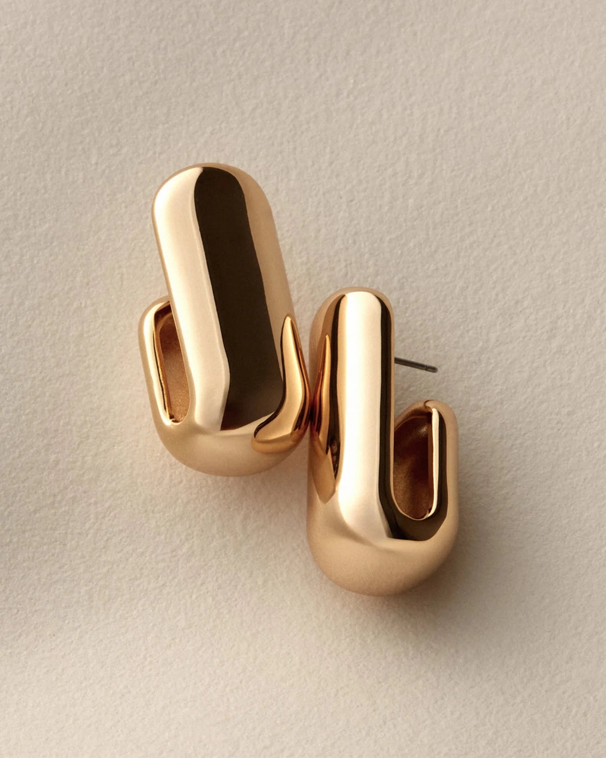 gold plated hoops on a white background