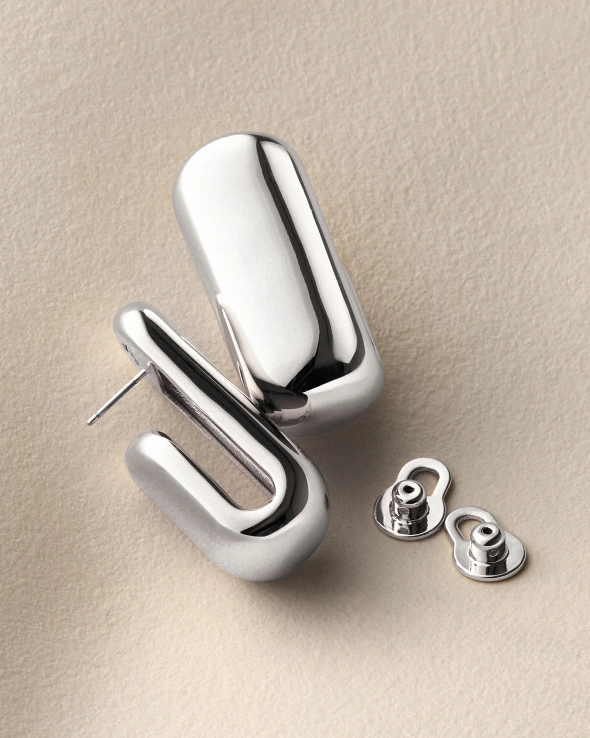 silver chunky earrings on a white background