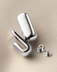 silver chunky earrings on a white background