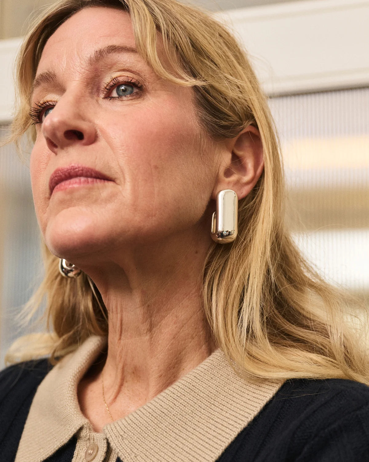 model wearing chunky silver earrings 