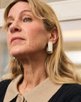 model wearing chunky silver earrings 