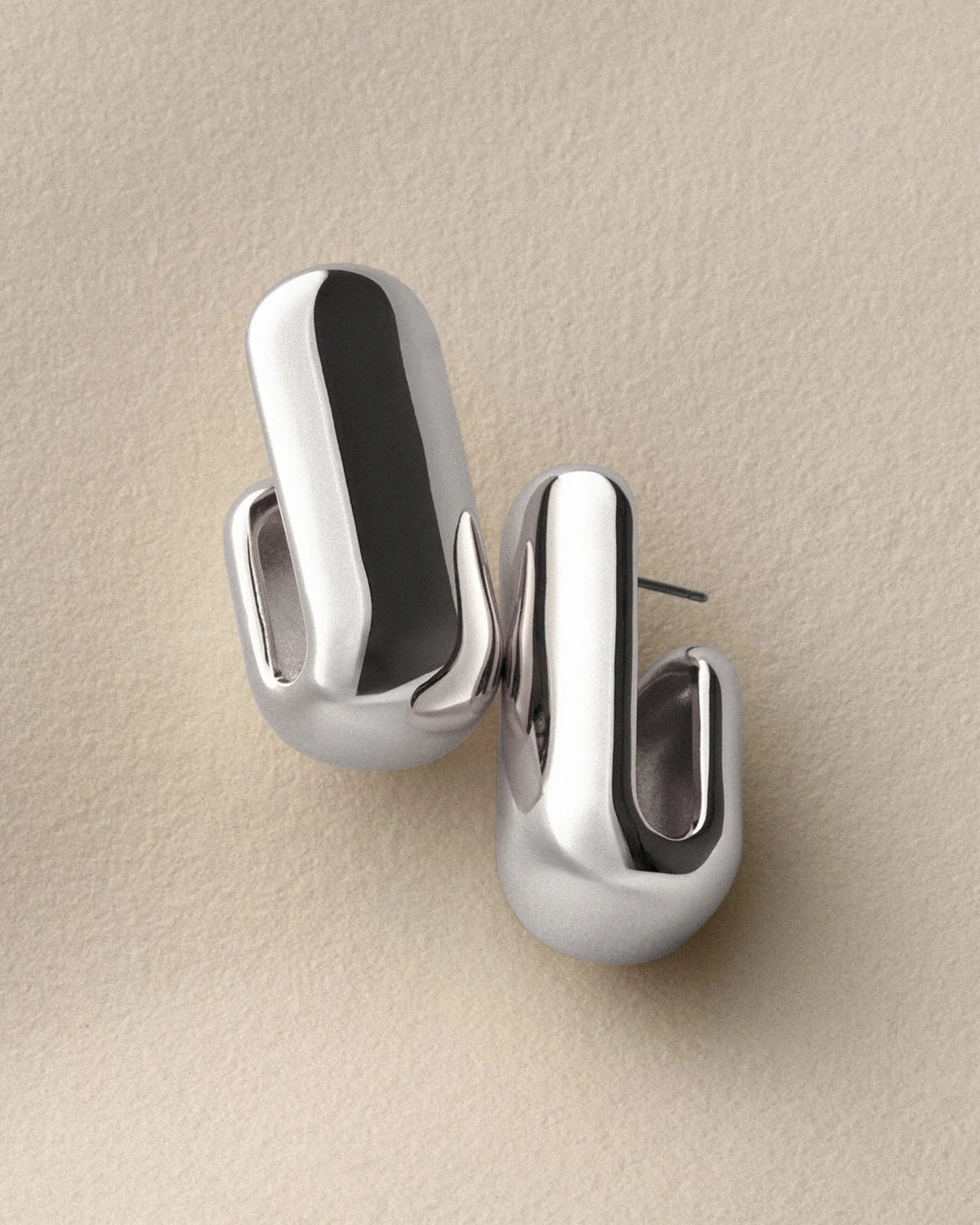 silver chunky earrings on a white background