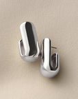 silver chunky earrings on a white background