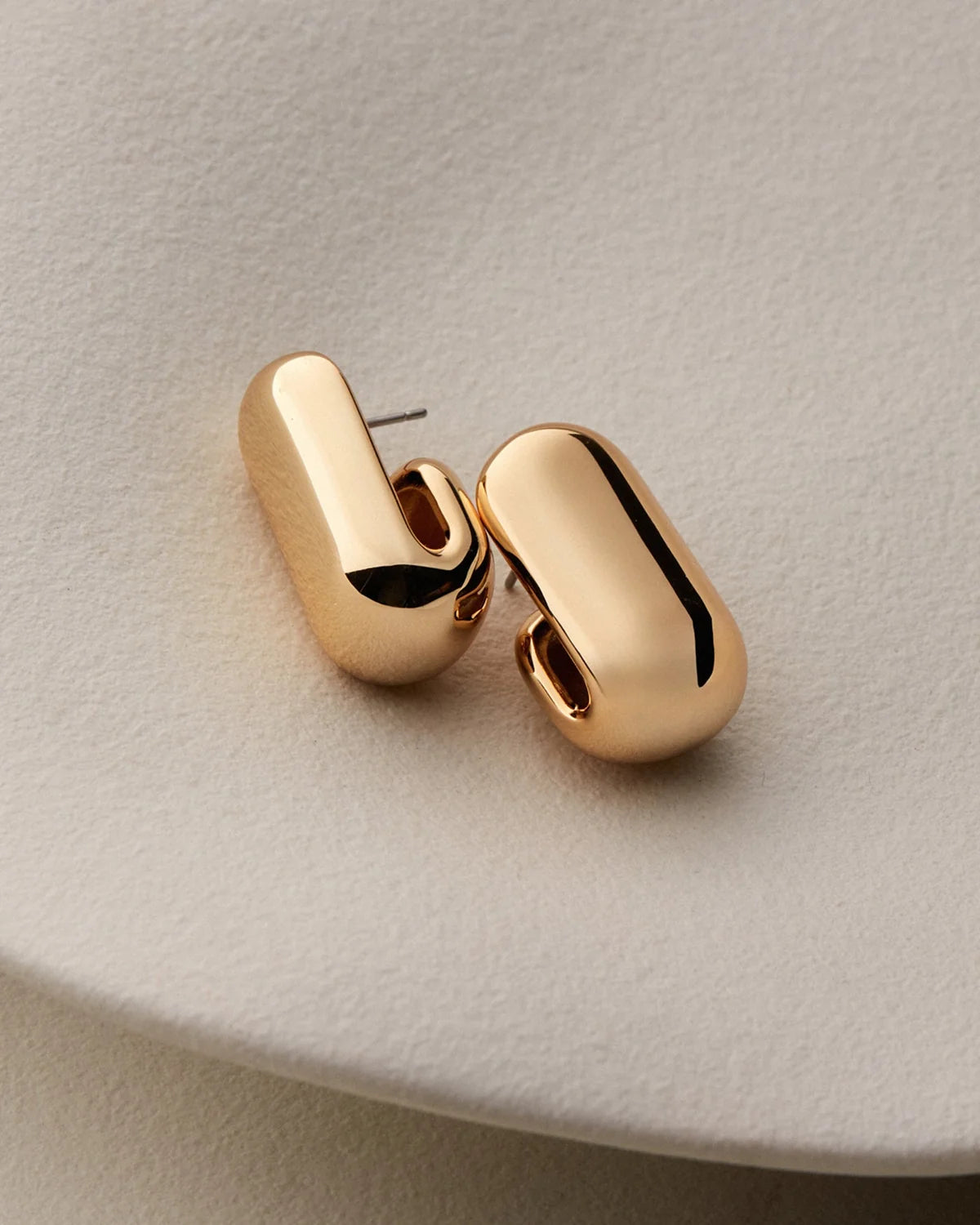  gold earrings on a white background