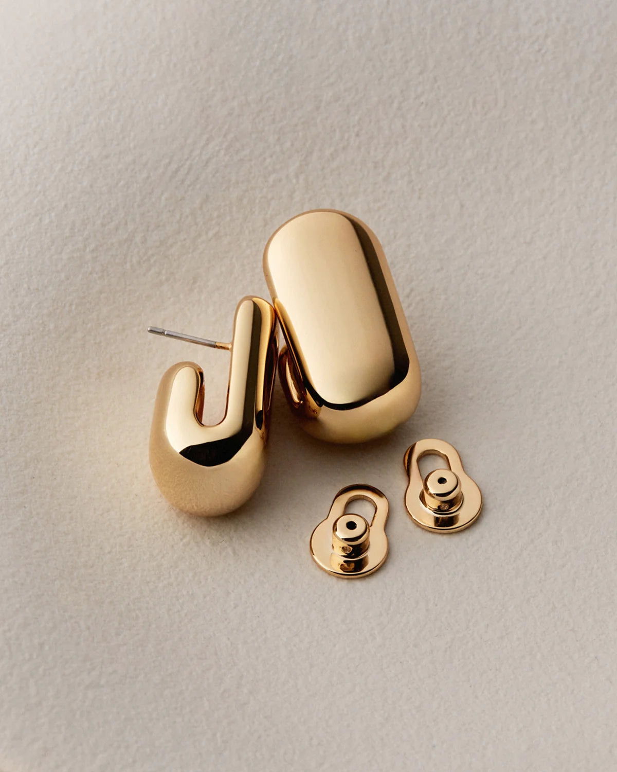 gold earrings on a white background
