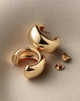 chunky gold hoops on a white background