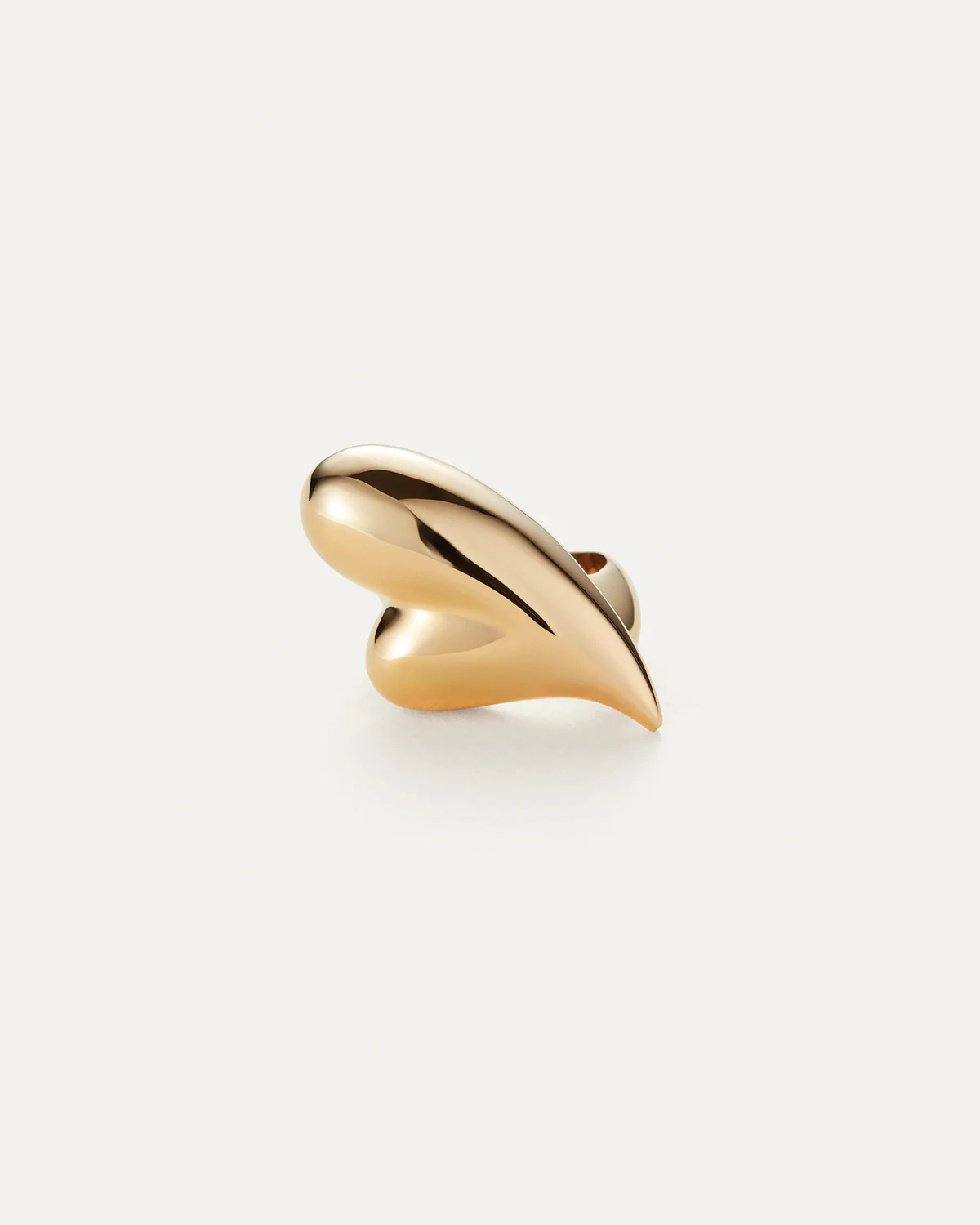 Gold ring with a wavy design on a white background