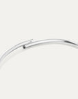 Silver bracelet on a light gray background