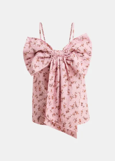 Pink floral top with bow detail on a light pink background