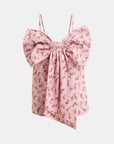 Pink floral top with bow detail on a light pink background