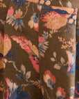 Floral patterned fabric with colorful flowers on a brown background