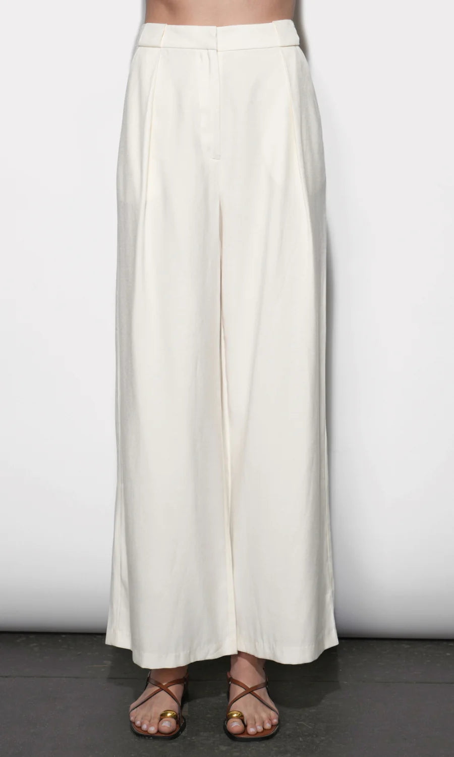 White wide-leg pants worn by a person on a plain background