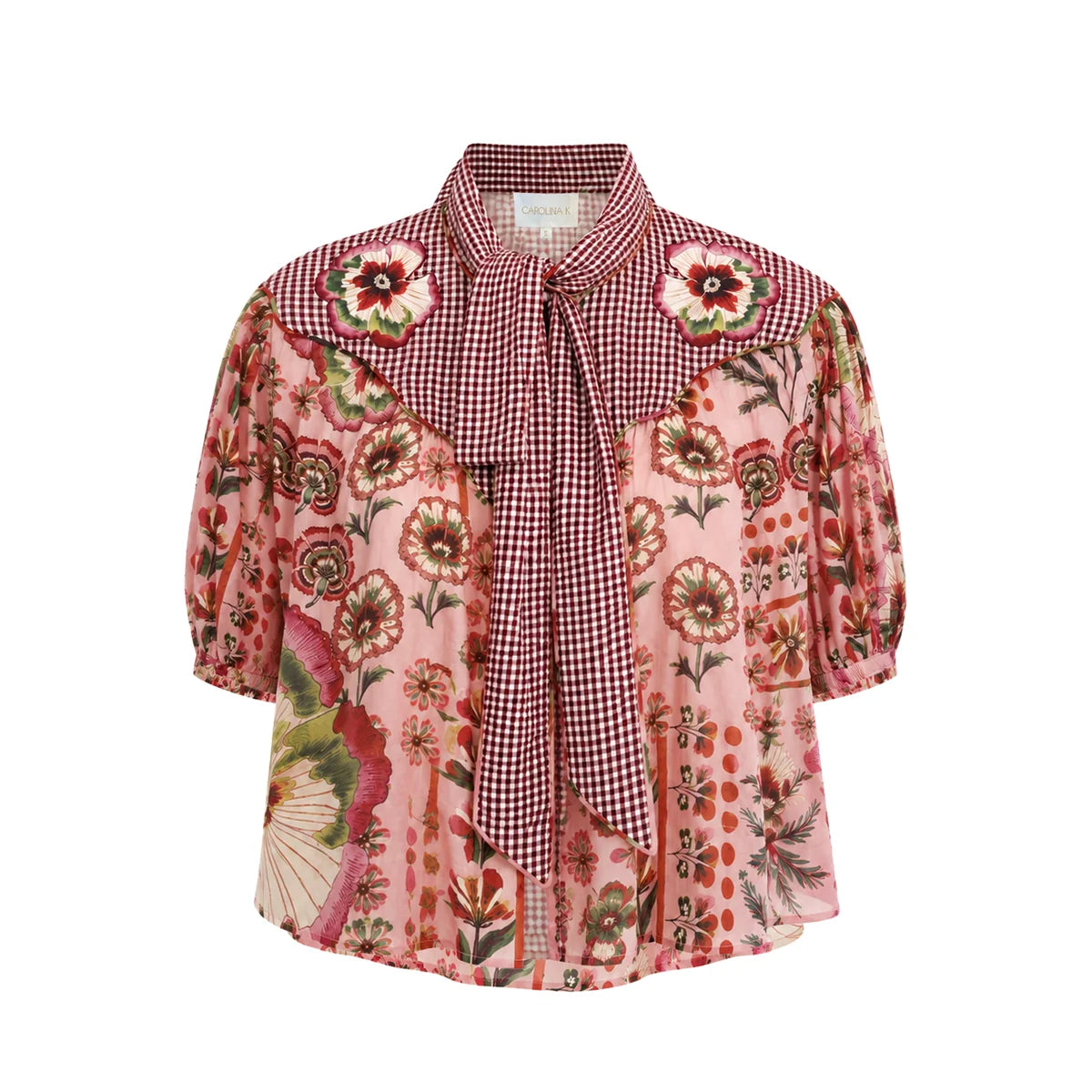 A women's short-sleeve blouse featuring a pink floral print on the body, a red and white gingham pattern on the yoke and collar, and a matching red and white gingham tie at the front, displayed on a clean white background.