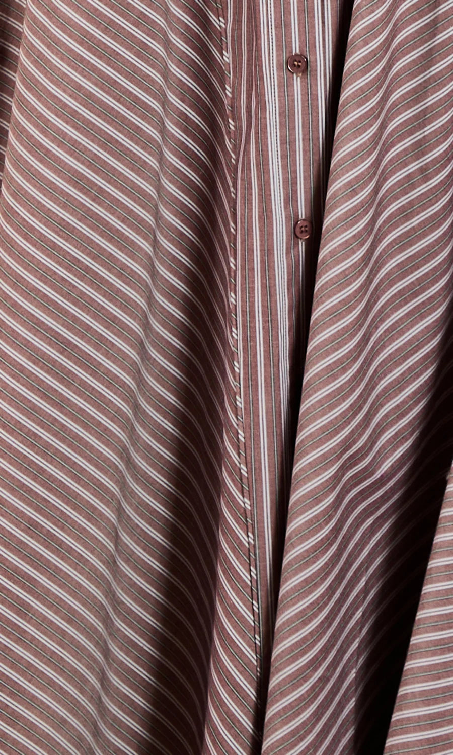 Close-up of a button-front shirt or blouse with a muted pinkish-brown base and thin white diagonal stripes, showing part of the front placket and buttons.