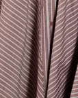 Close-up of a button-front shirt or blouse with a muted pinkish-brown base and thin white diagonal stripes, showing part of the front placket and buttons.