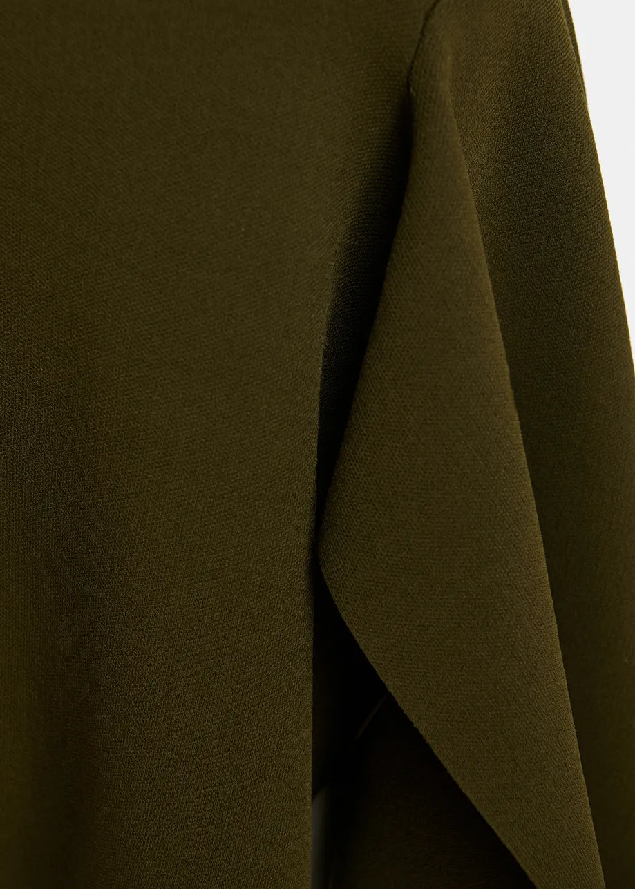 Close-up of a dark olive green draped fabric, showing the texture and a folded corner.